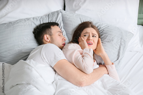 Young irritated woman in be...