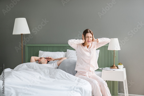 Young irritated woman in be...