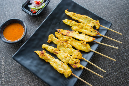 satay chicken on top view and black plate for advertisement