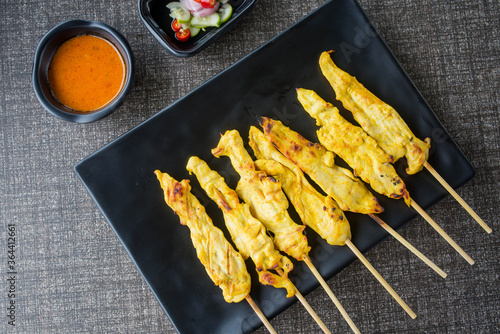 satay chicken on top view and black plate for advertisement