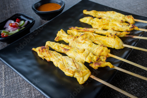 satay chicken on top view and black plate for advertisement