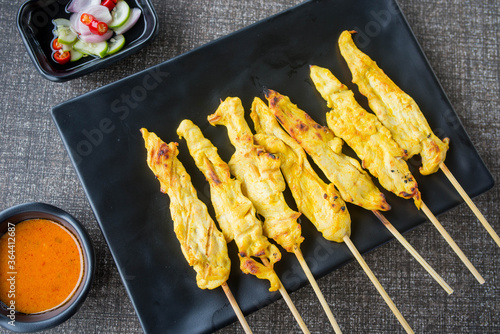 satay chicken on top view and black plate for advertisement