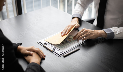 Foto Asian man gave a bribe to a female employee in the office.