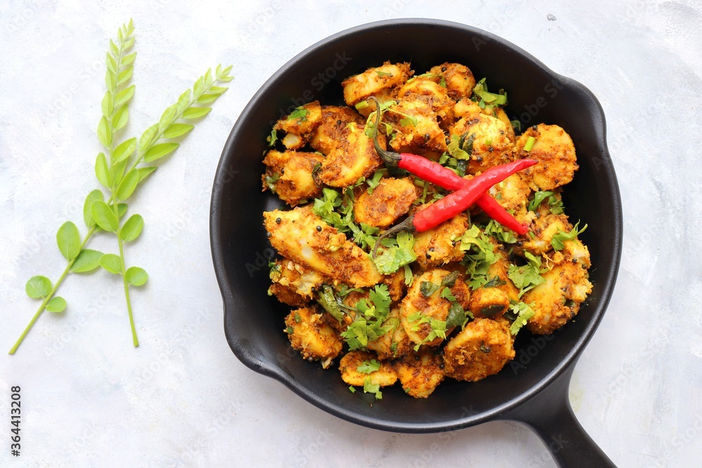 Stir fried taro roots. Arbi ki sabji, Taro roots masala curry. Arbi Masala. Garnished with coriander, red chili & curry leaves. copy space. Stir fried taro roots. Arbi ki sabji, Taro roots masala curry. Arbi Masala. Garnished with coriander, red chili & curry leaves. copy space.