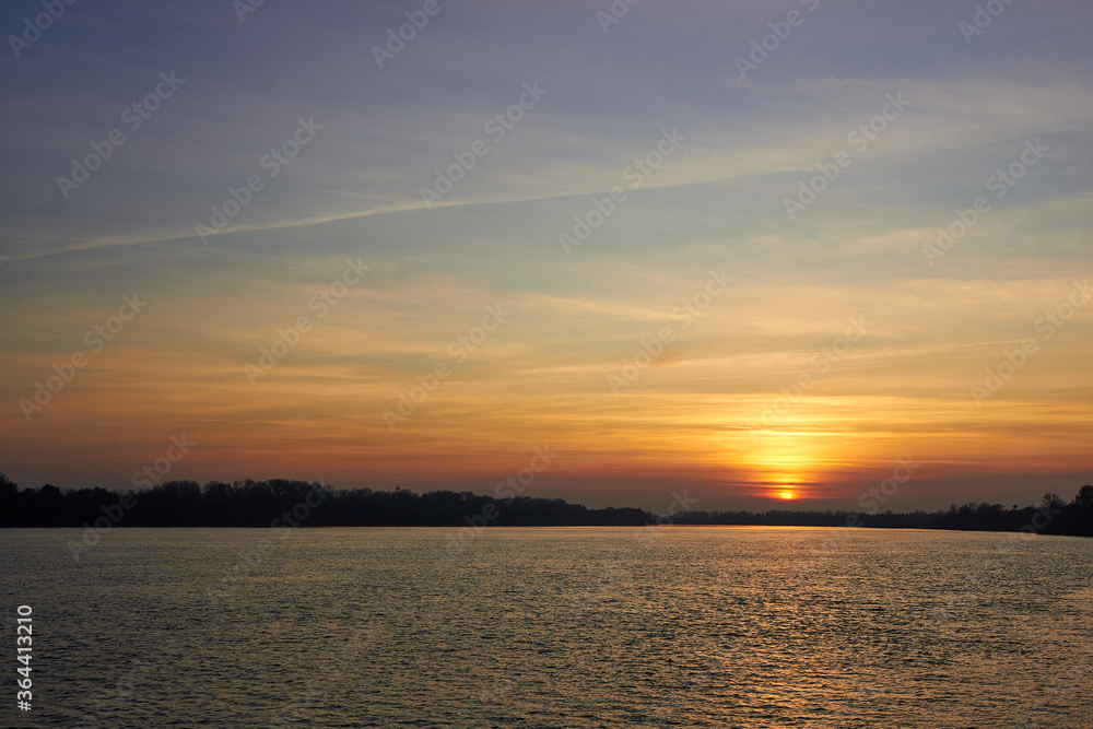 Obraz premium Sunset over danube river at the autumn. Evening over river landscape