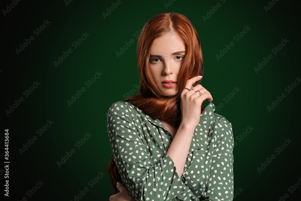 Beautiful young redhead woman on dark background Beautiful young redhead woman on dark background