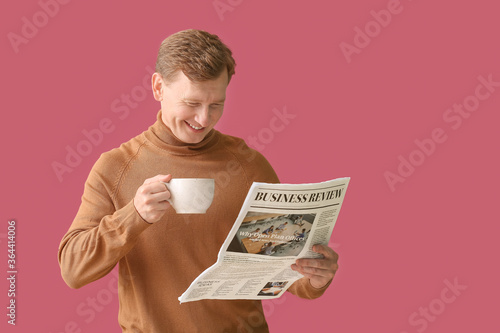 Handsome man with cup of te...