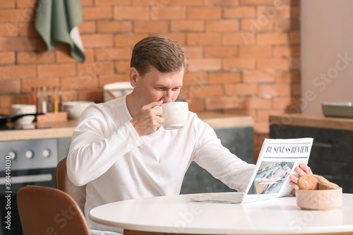 Handsome man with newspaper...