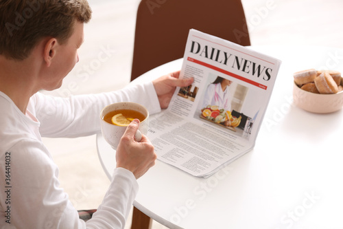 Handsome man with newspaper...