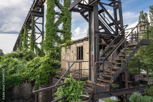 old industrial site grown over with ivy