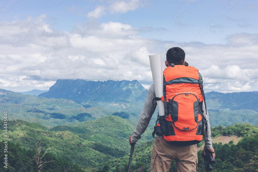 Young man with backpack on top mountain