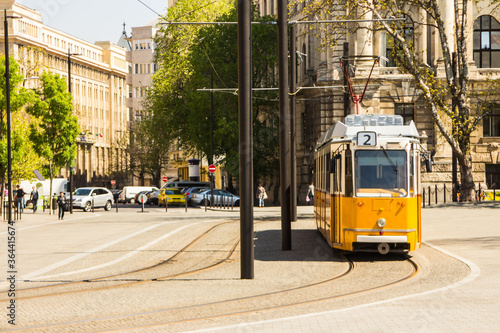 Historic yellow tram on the street of Budapest. Hungary