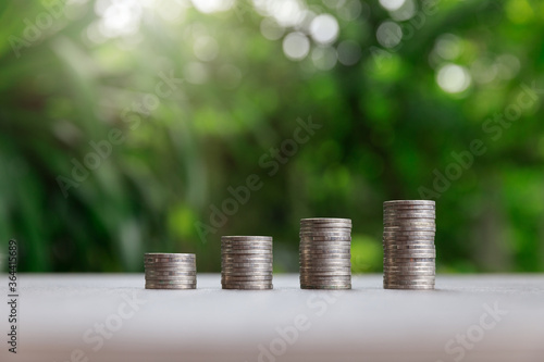 Property investment and house mortgage financial concept, Coin stack on green background.