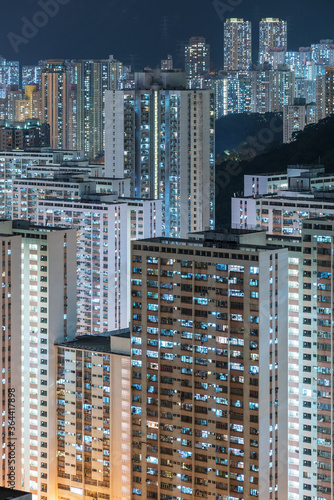 Crowded residential buildings in Hong Kong city at night photo