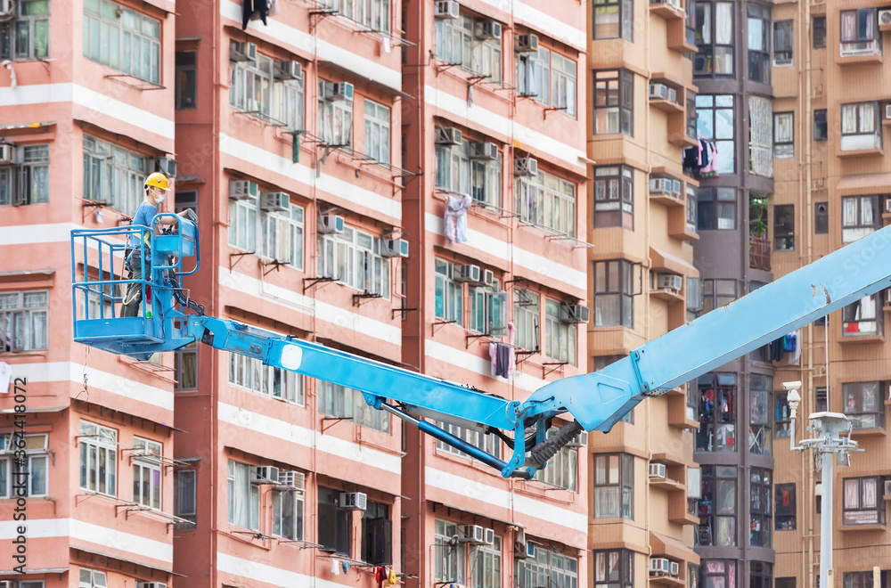 Worker on crane in construction site in Hong Kong