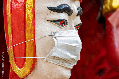 Fotografie The portrait of the historical thai soldier with face mask, Wat​ Muang​ temple​ located​ Ang​ Thong and Ayutthaya​ during coronavirus pandemic, Thailand