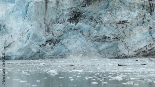 Big chunk of ice calving from Margerie Glacier. Climate change in Alaska. photo