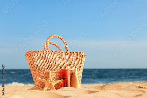 Bag with sunscreen cream on beach
