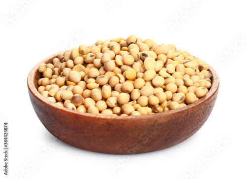 Plate with raw soy beans on white background