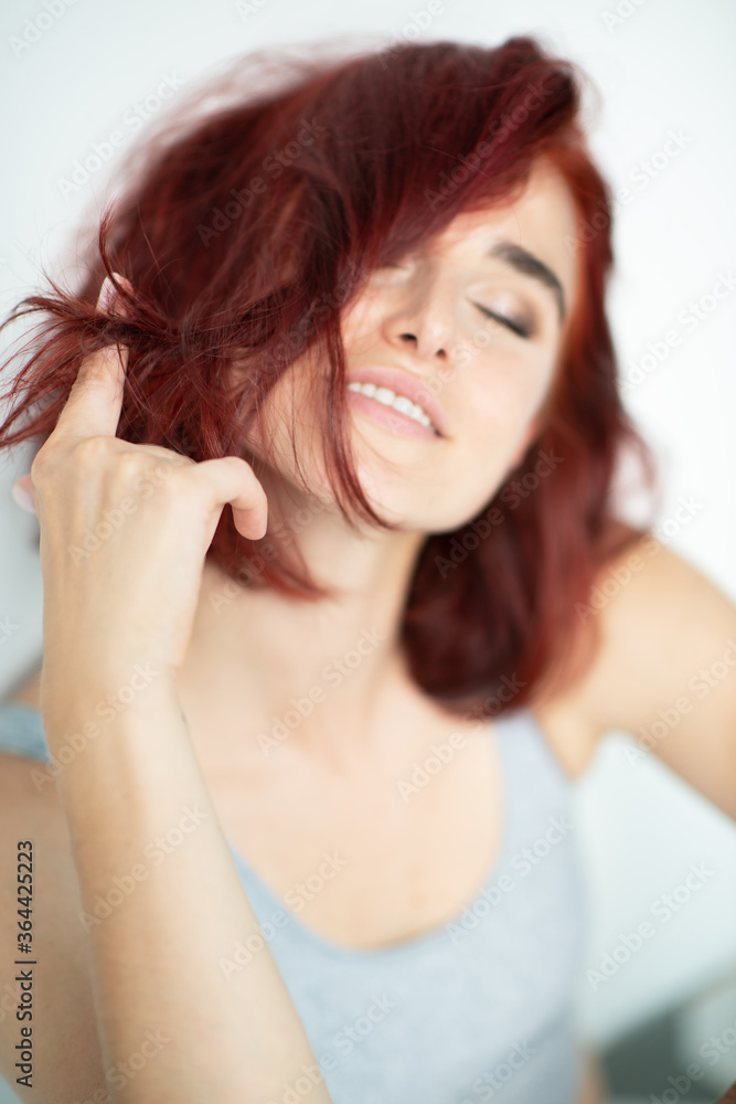 Beautiful young ginger woman with freckles and blue eyes. Portrait of charming girl wearing casual clothes posing at home Beautiful young ginger woman with freckles and blue eyes. Portrait of charming girl wearing casual clothes posing at home
