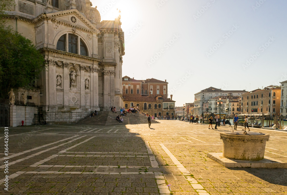 Venice, Italy, april 2018. A back light shot of the little square in front of the beautiful church 