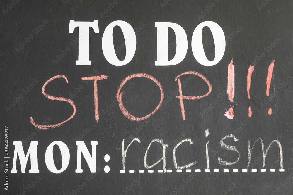Todo list with text STOP RACISM, closeup