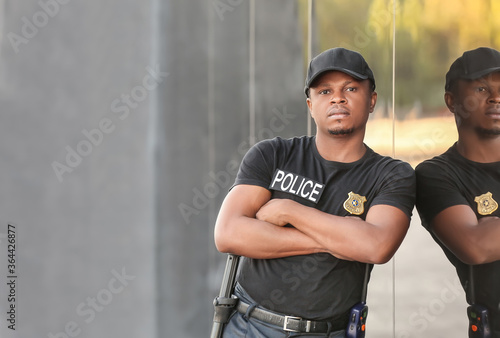 Bild auf Leinwand African-American police officer in the street