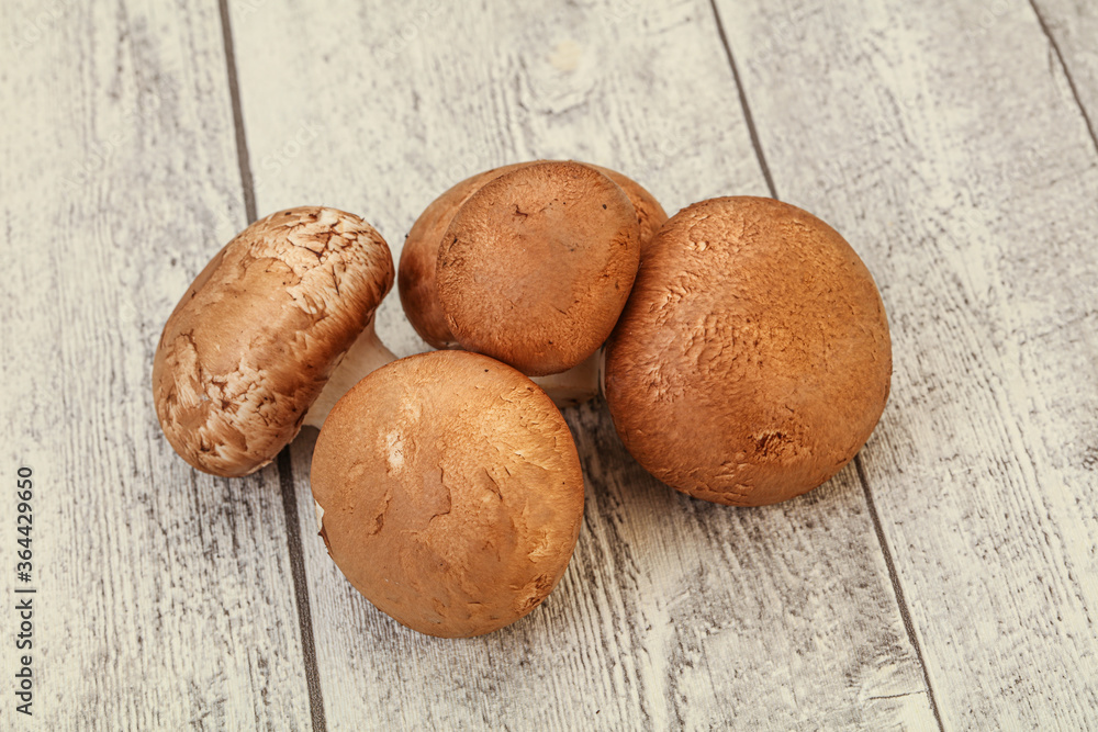 Raw Brown Champignons over background Raw Brown Champignons over background