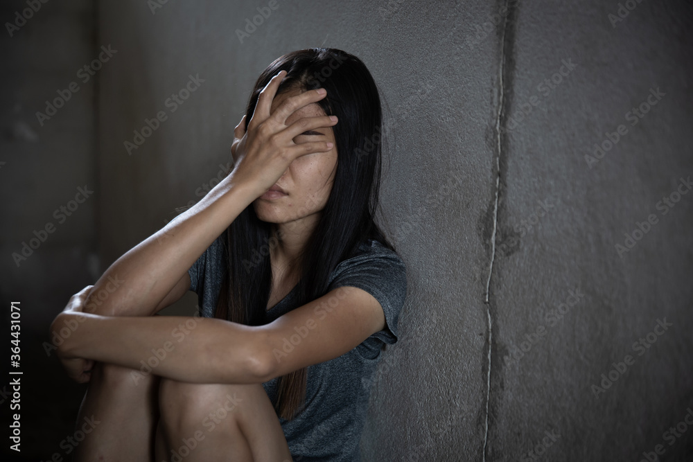 Depression or domestic violence Concept, Black and white image of a young woman crying and covering her face useful to illustrate stress. Depression or domestic violence Concept, Black and white image of a young woman crying and covering her face useful to illustrate stress.