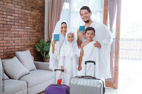 muslim umrah and hajj with family showing passport photo