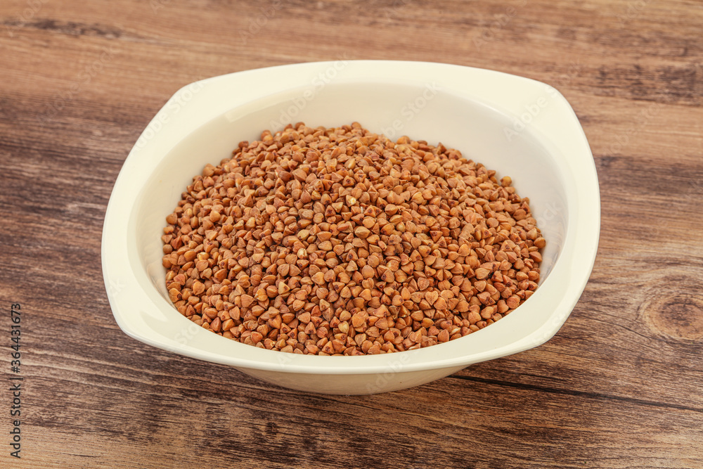 Raw buсkwheat cereal in the bowl Raw buсkwheat cereal in the bowl