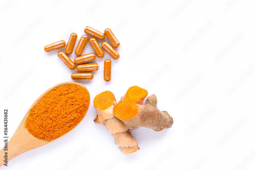 Tumeric ( curcumin, Curcuma longa Linn) powder in wooden spoon and turmeric  capsules isolated on white background. Supplement concept. Top view. Flat  lay. Stock Photo | Adobe Stock