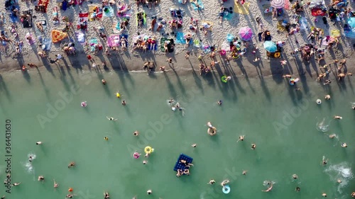 overcrowded beach vacation top view. Having fun on beach summer vibes. Original aerial drone artistic creative composition from above unusual perspective. Odessa Ukraine Black sea resort Video footage