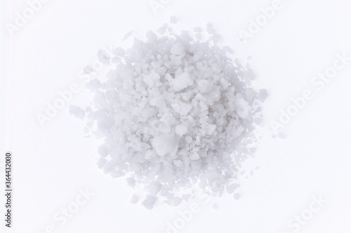 Closeup  pile of coarse or rock natural sea saltisolated on white background Top view. 