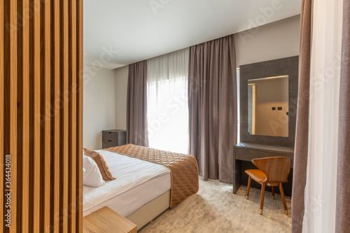 Interior of a luxury hotel bedroom in mountain hotel resort with wooden wall
