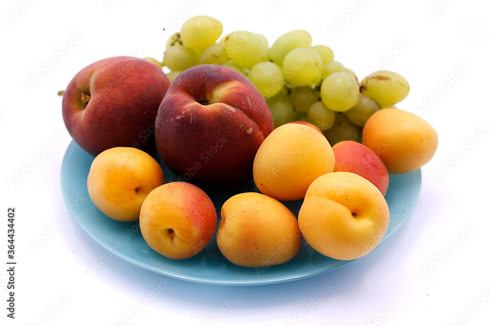 Grape bunch, peaches and apricot close-up on a white background Grape bunch, peaches and apricot close-up on a white background