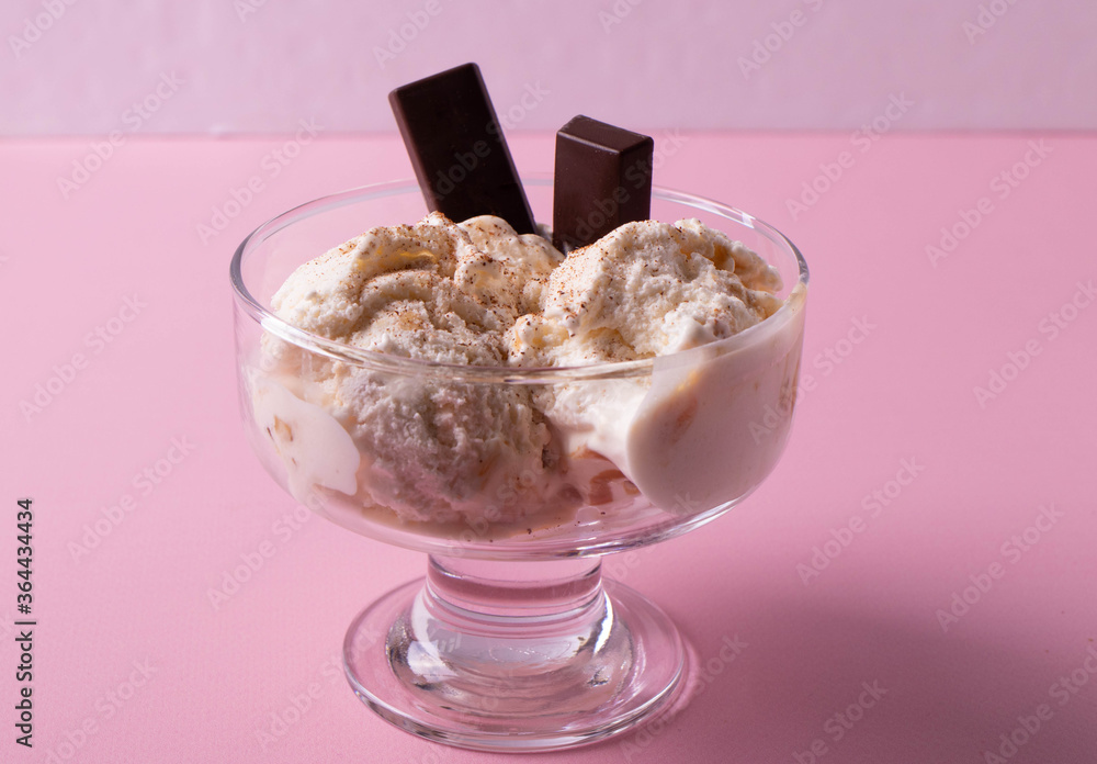 delicious creamy milky vanilla ice cream with caramel and chocolate addings in a glass container delicious creamy milky vanilla ice cream with caramel and chocolate addings in a glass container