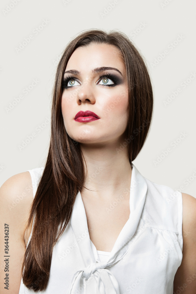 Atrractive young brunette woman looking up in studio Atrractive young brunette woman looking up in studio