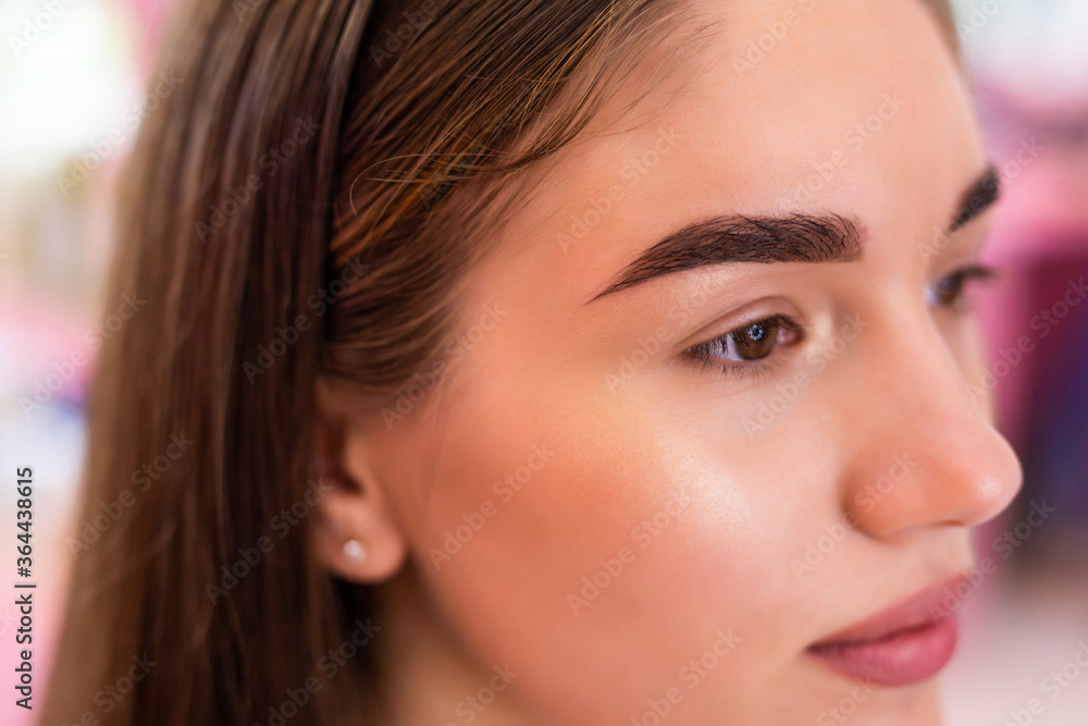 Obraz premium Make-up artist woman eyebrows close up. Professional makeup and cosmetology skin care.