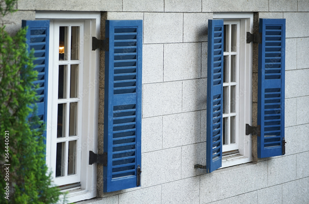 white window with blue shutters