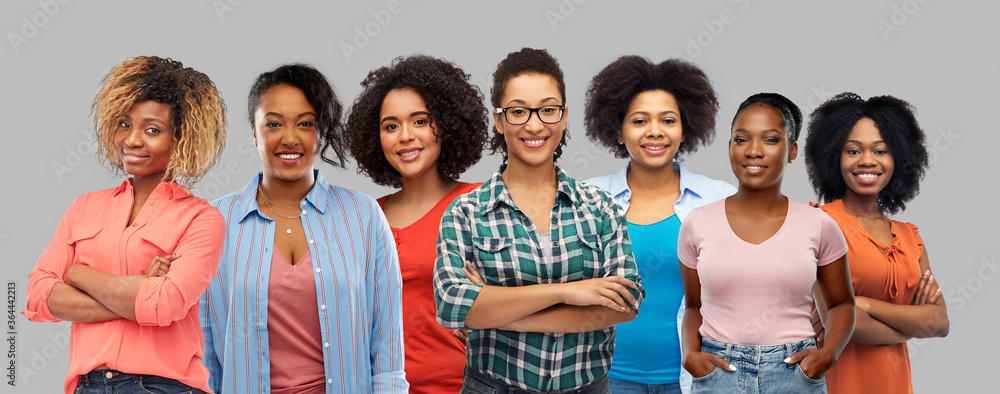 civil rights, ethnicity and people concept - group of happy african american women over grey background - obrazy, fototapety, plakaty 