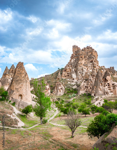 A view of a path leading to Uchisar Castle through a valley of fairy chimney rock formations near Goreme in Nevsehir Province, Cappadocia, Turkey