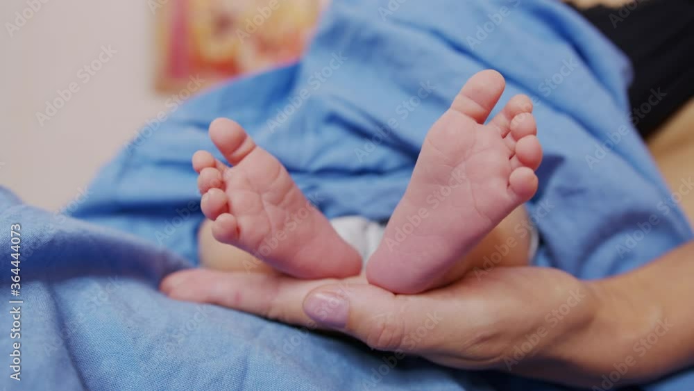 Little feet of a newborn baby. Caring for a child. Closeup. Little feet of a newborn baby. Caring for a child. Closeup.