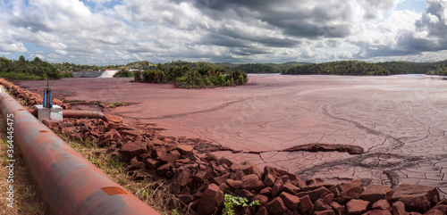 Mine tailings reservoir in Africa, receiving slurry through a pipeline from an ore processing plant.