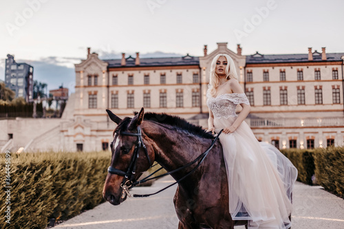 Beautiful woman with horse near castle