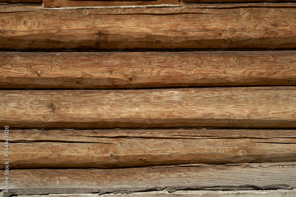 A wall made of natural wood of different sizes and shapes, Log house or barn, textured horizontal walls A wall made of natural wood of different sizes and shapes, Log house or barn, textured horizontal walls