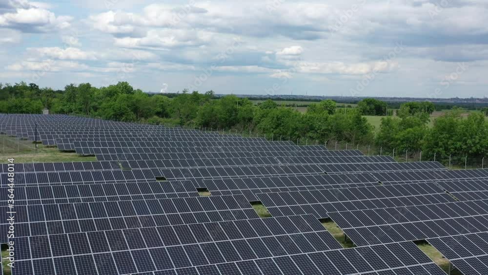 Massive solar power station in the field, lots of solar panels, aerial shot, 4k Massive solar power station in the field, lots of solar panels, aerial shot, 4k