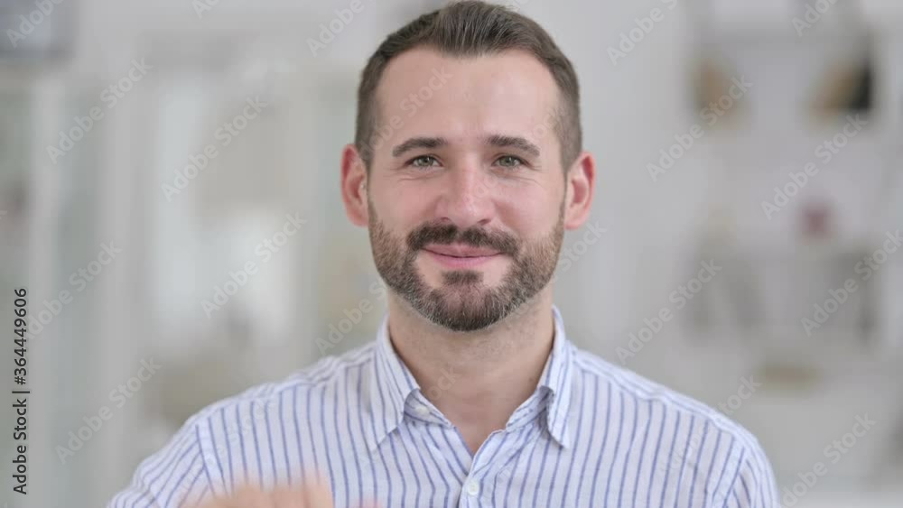 Portrait of Young Man showing Victory Sign by Hand Portrait of Young Man showing Victory Sign by Hand