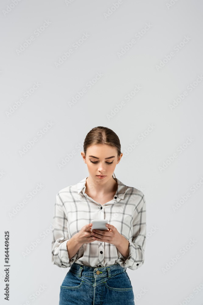 attractive girl using smartphone isolated on grey attractive girl using smartphone isolated on grey