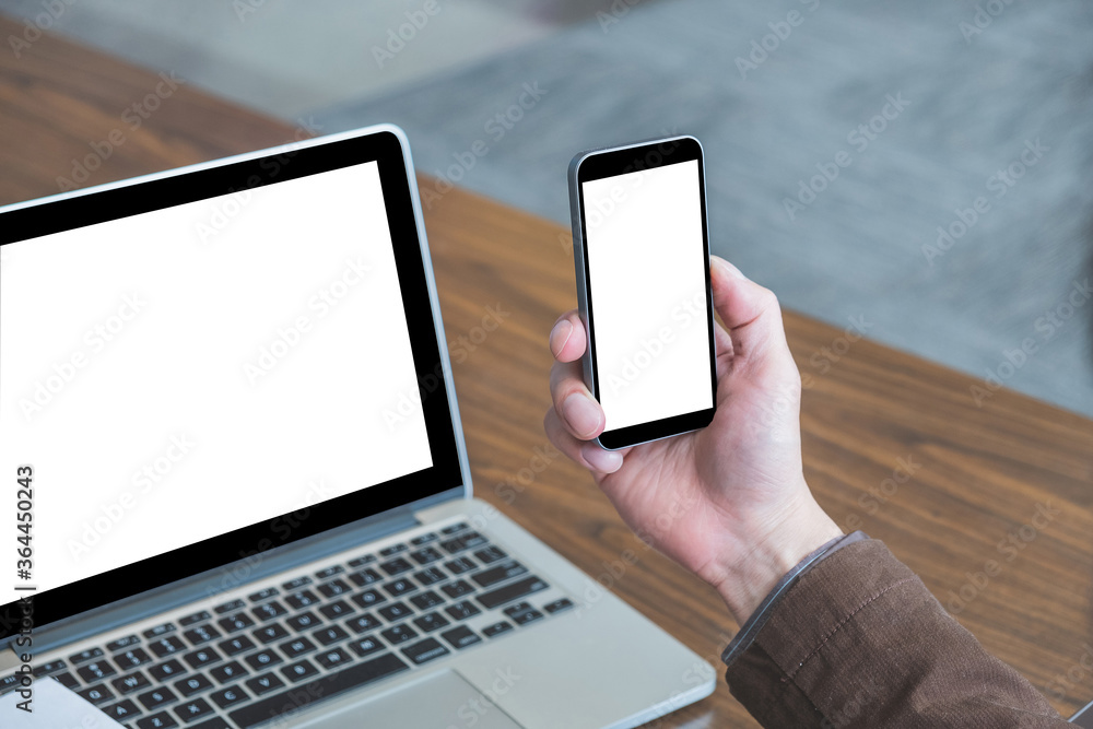 Mock up image of male hand holding blank screen smart phone.